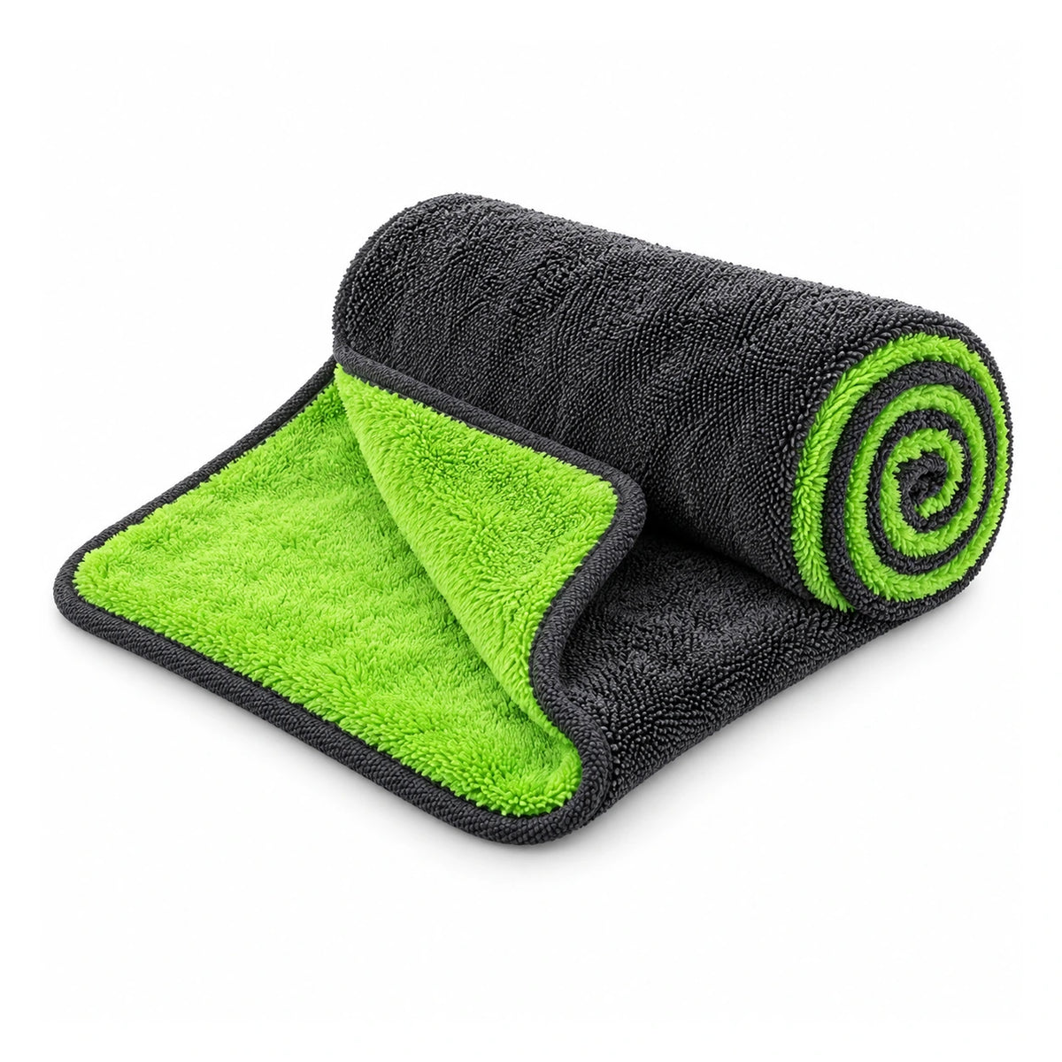 One charcoal-gray and lime-green dual-sided microfiber drying towel partly unrolled on white to show both faces and bound edges.