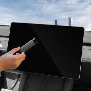 Black microfiber screen cleaner wiping a vehicle touchscreen