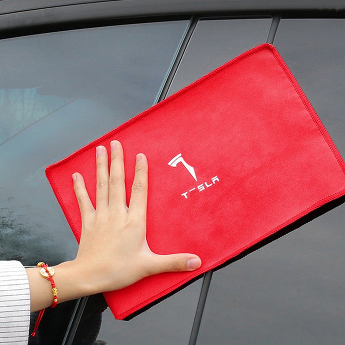 Red smooth face of the microfiber towel laid on a car hood